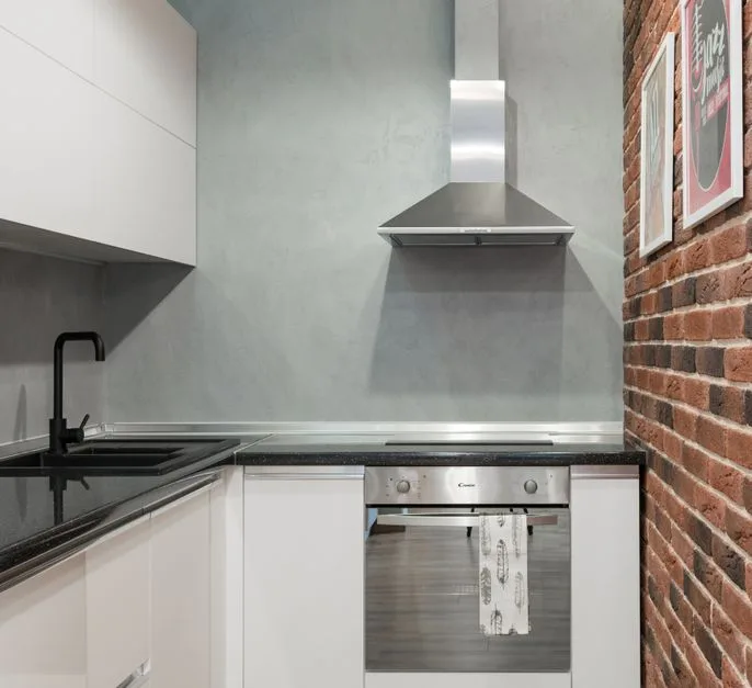 Stainless steel commercial kitchen hood above cooking line in Hammonton restaurant